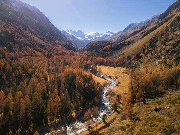 istock Sunny autumn in snowy mountains 2197284563