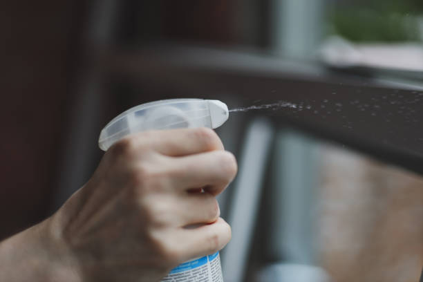 istock Caucasian male builder splashes detergent on the window frame. 2197289396