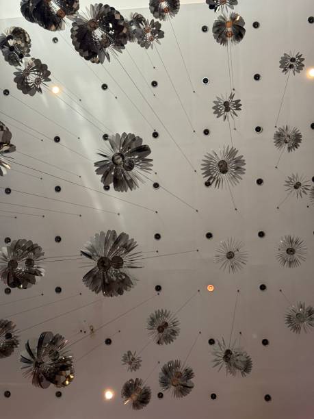 A unique and artistic ceiling design featuring circular glass elements, creating a mesmerizing pattern.