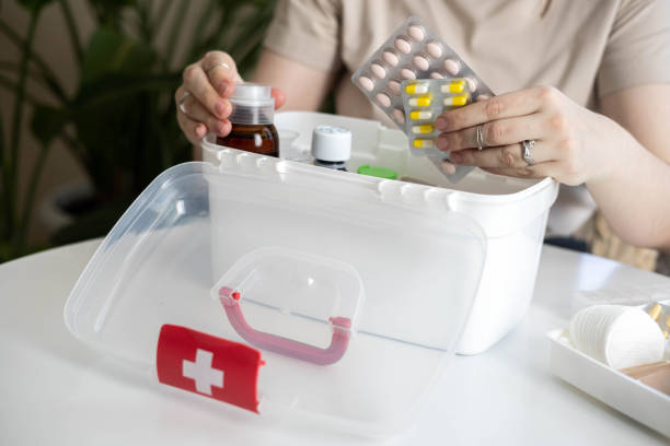 istock Closeup female hand placing medicament domestic first aid kit. Storage organization emergency supply 2197292112
