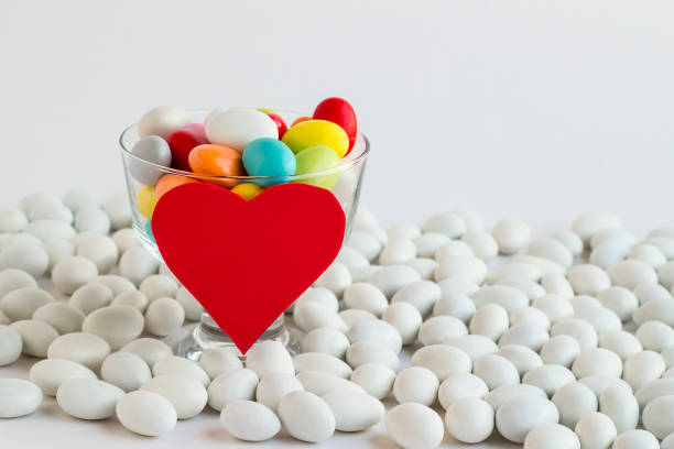 Traditional Turkish colorful almond candies,in transparent glass bowl with red color heart shaped card