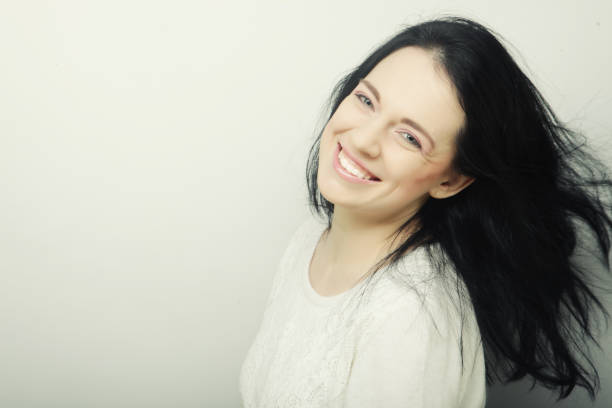 Beautiful young happy brunette woman. Studio shot.