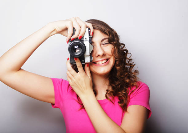young curly woman with vintage camera