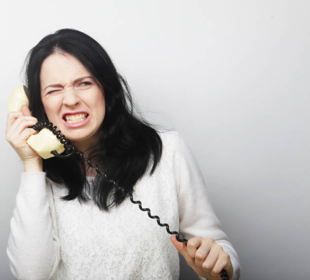 furious  young girl with vintage phone