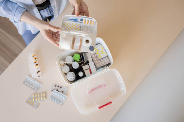 istock Closeup female hand placing medicament domestic first aid kit. Storage organization emergency supply 2197294921
