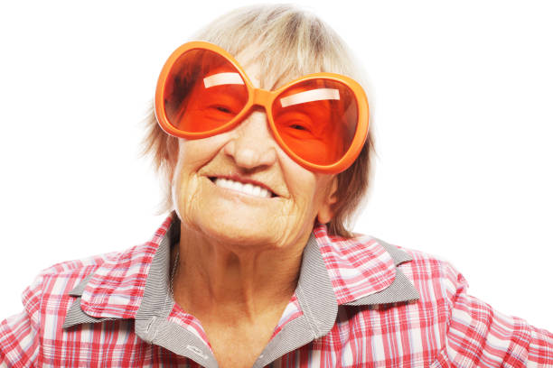 Senior woman wearing big sunglasses doing funky action isolated on white background