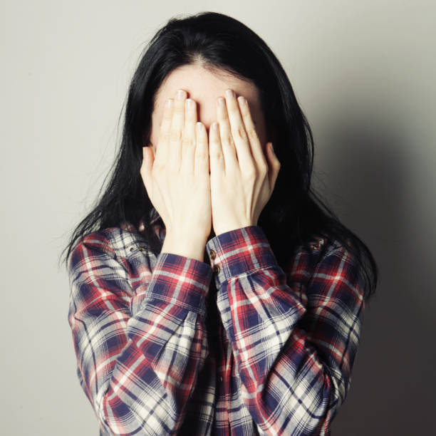 istock Young woman covering her eyes with her hands. 2197296699