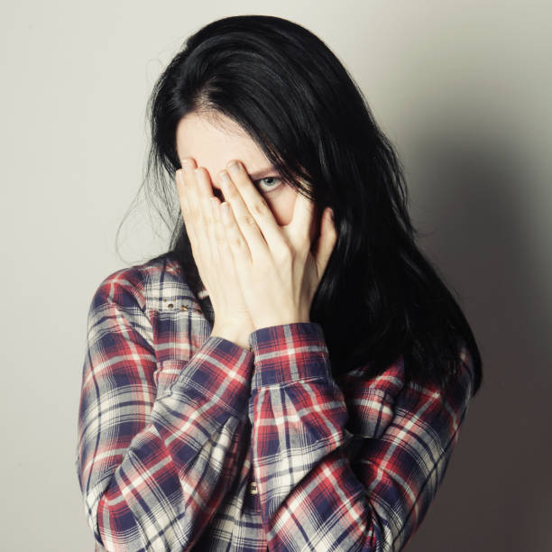 istock Young woman covering her eyes with her hands. 2197296708