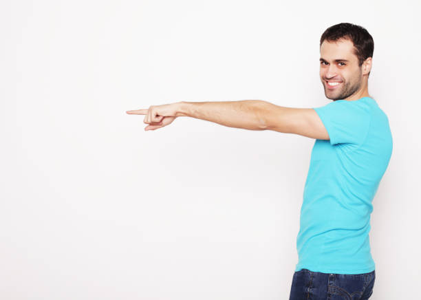 istock Young smiling happy man shows something 2197297394