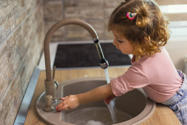 istock Beautiful little girl washing hands 2197298540