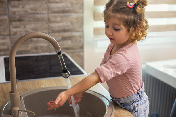 istock Beautiful little girl washing hands 2197298546