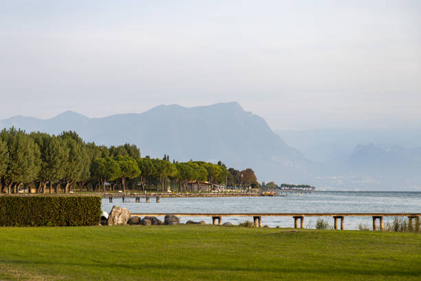 istock Grass, trees, and mountains framing Lake Garda in Sirmione 2197303834