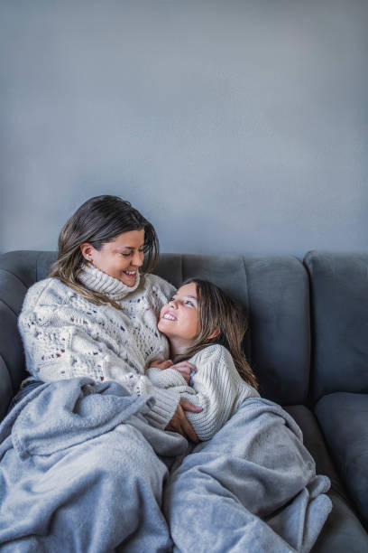 istock Mother and daughter sharing a tender moment on the sofa 2197304015
