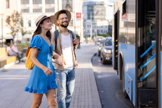 istock Couple exploring city surroundings with backpacks by a bus 2197307681