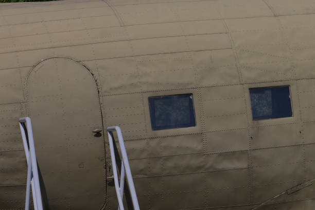 Fuselage fragment with door, illuminator, ladder, stepladder.