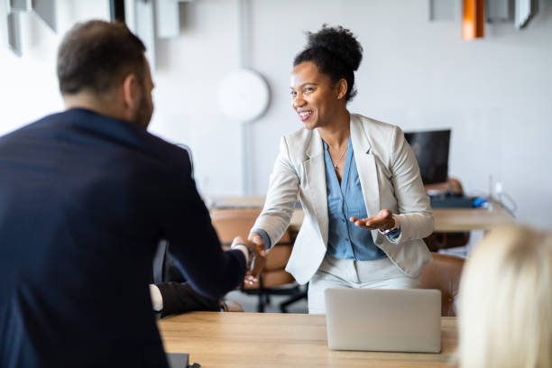 istock Business Meeting Handshake in Modern Office Setting 2197308454
