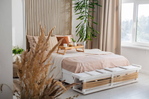 istock Modern bedroom with natural decor and cozy seating area in bright light 2197308521