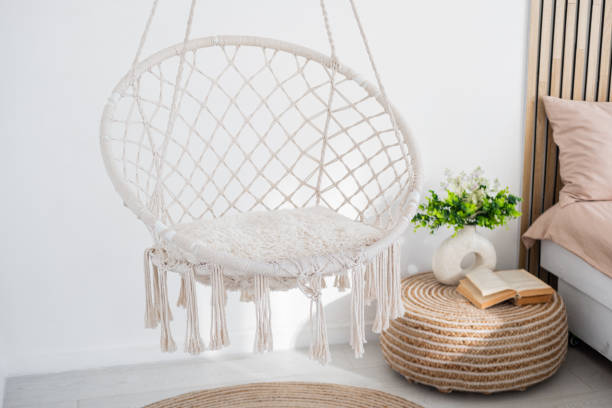 istock Hanging macrame chair enhances cozy bedroom decor and comfort 2197308528