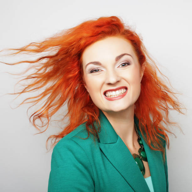 Young happy red woman with wind in hair