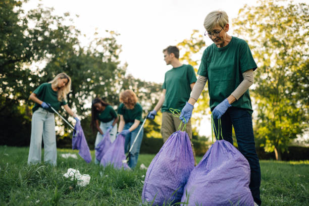 istock Group of volunteers collecting garbage in public park 2197310562