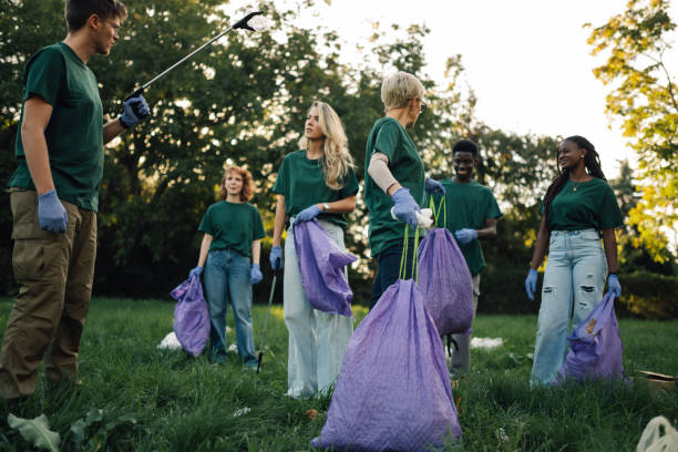 istock Group of volunteers collecting garbage in park 2197310570