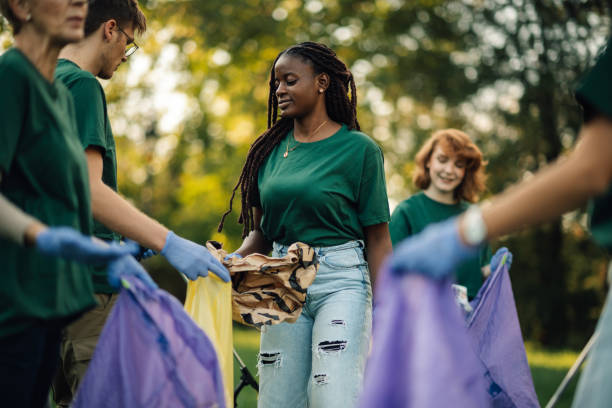 istock Group of volunteers collecting garbage in park 2197310582