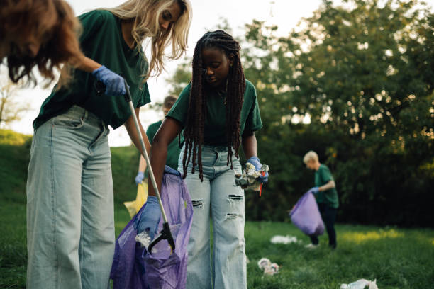 istock Group of volunteers picking up trash in park 2197310593