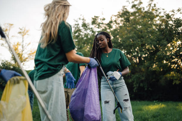 istock Group of volunteers collecting garbage in park 2197310604