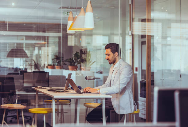 istock Focused Businessman Engaging with Technology in Modern Office 2197311022