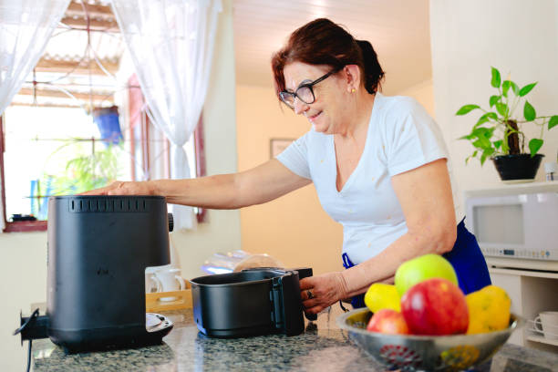 istock Mature woman using an air fryer 2197311740