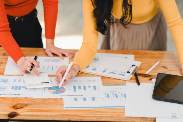 istock Collaborative work on financial reports and charts, showcasing analysis and strategy development. scene highlights teamwork and productivity in professional setting 2197313945