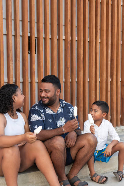 istock Happy family eating ice cream outdoors on steps 2197317903