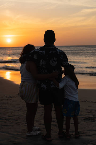 istock Father and daughter sharing a tender moment on beach at sunset 2197318224