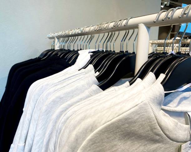 istock plain black and grey shirts or sweaters, hanging neatly in a clothing store 2197318831