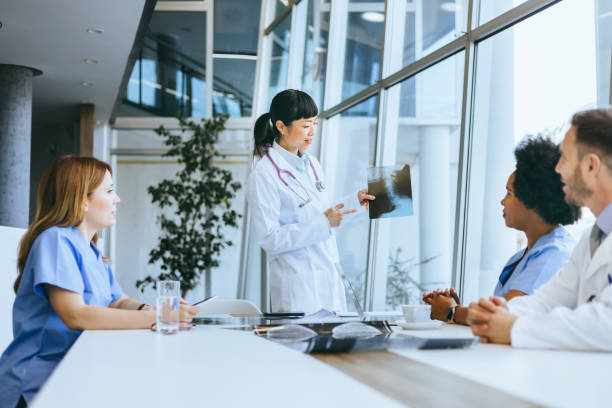 istock Nurse holding an X-ray in a team meeting 2197318861
