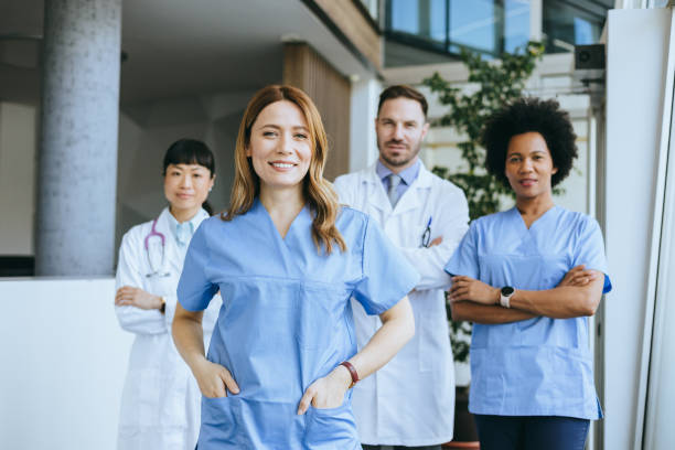 istock Confident nurse leading with doctors in background 2197318875