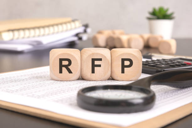 istock RFP- Request For Proposal word written on a wooden block with magnifier and calculator, business concept. 2197320101
