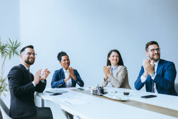 istock Team clapping in a business meeting 2197320439