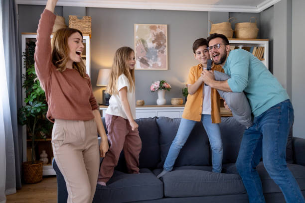 istock Family sharing a joyful moment singing karaoke 2197320918
