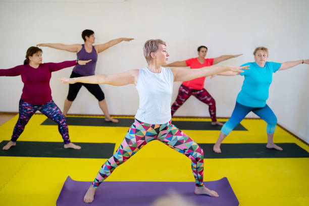 istock Group yoga session with warrior two pose 2197321280
