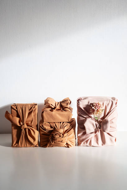 istock Gift boxes wrapped in reusable fabric, promoting waste reduction and sustainable gifting ideas. 2197326410