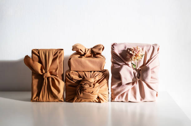 istock Gift boxes wrapped in reusable fabric, promoting waste reduction and sustainable gifting ideas. 2197326411
