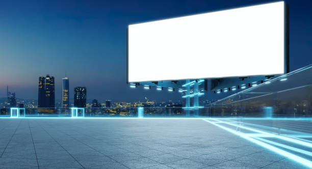 istock Blank billboard on futuristic rooftop with city skyline at dusk 2197330089