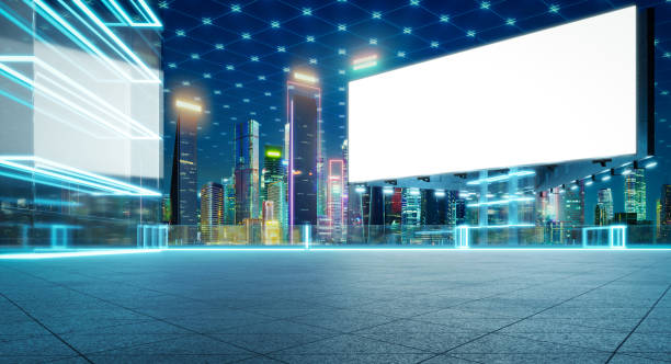 istock Futuristic billboard showing a blank white screen in a smart city with neon lights 2197330096