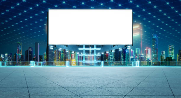 istock Blank billboard standing on rooftop with illuminated futuristic cityscape view at night 2197330106