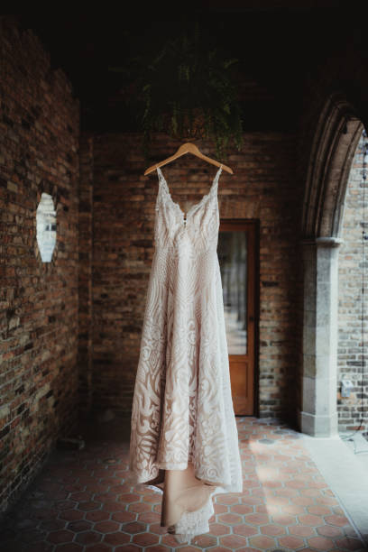 istock Lace wedding dress hanging up before wedding ceremony 2197333660