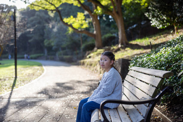 istock Little girl relaxing in public park 2197335086