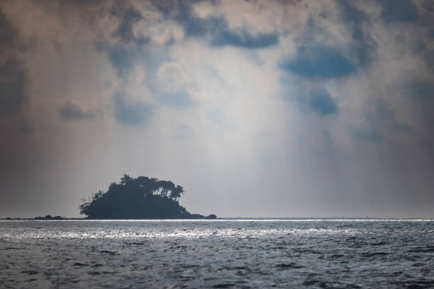 Tropic island on middle of the Ocean with cloudy sky background.\nPhuket Island - Thailand.