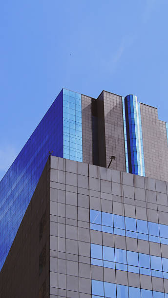 istock Urban Elegance in Architecture  A Masterful Display of Modern Glass and Concrete Design, Highlighting Clean Edges, Vibrant Sky Reflections, and Balanced Proportions. Perfect for Contemporary Design Inspiration or Corporate Identity Development 2197335682