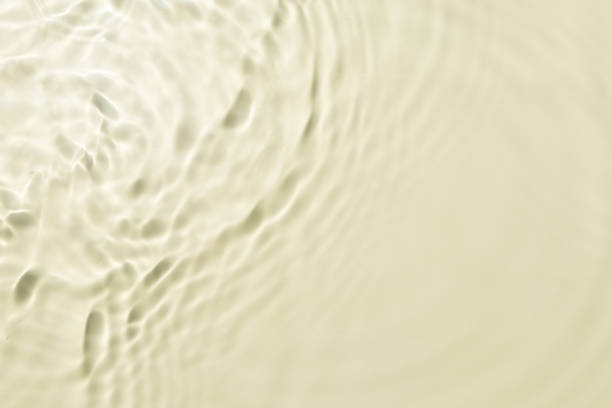 istock Top view background summer natural Beige surface, clear water with ripples and splashes. water waves in sunlight The water surface has waves and concept background cosmetics moisturizer toner 2197336615